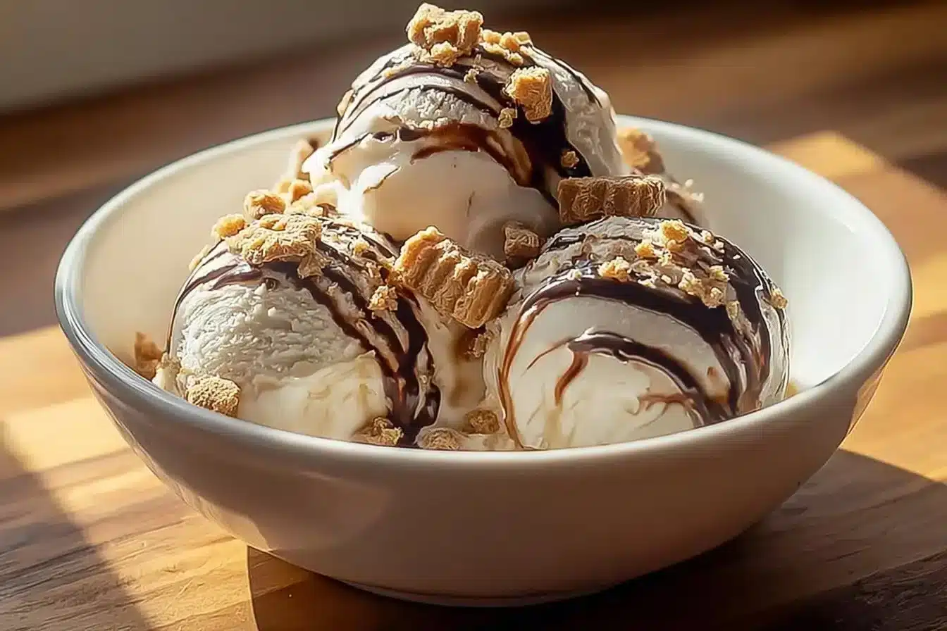 Delicious Peanut Butter Cup Ice Cream in a bowl topped with chocolate and peanuts