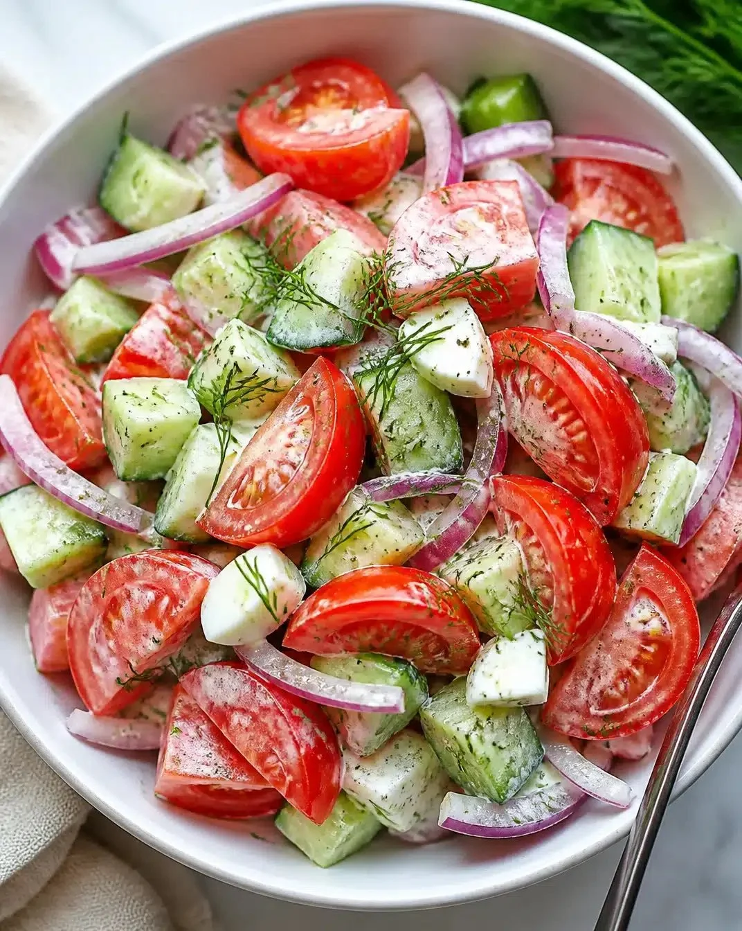 Fresh tomato salad with vegetables and herbs in a bowl