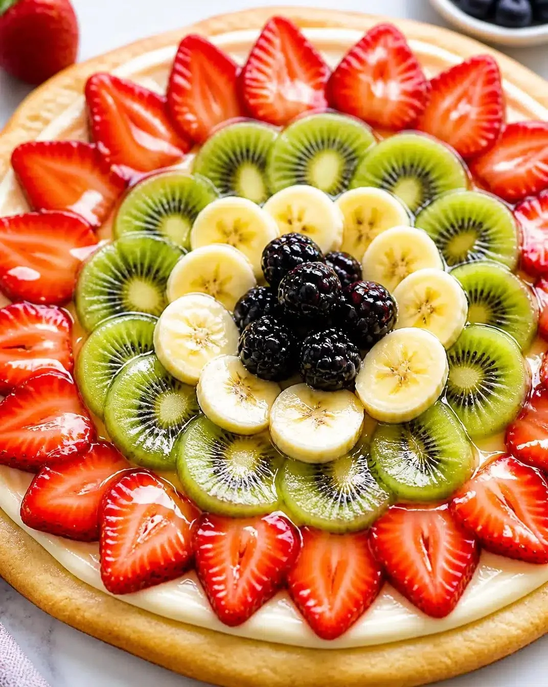 Delicious fruit pizza topped with fresh fruit and a sweet glaze